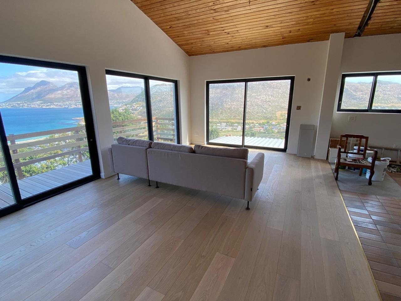 Engineered oak floor under a timber-clad vaulted ceiling with mountain views