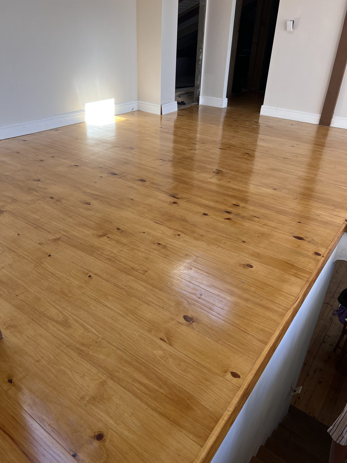 New pine floor stained an Oregon tone and sealed in a Kalk Bay home
