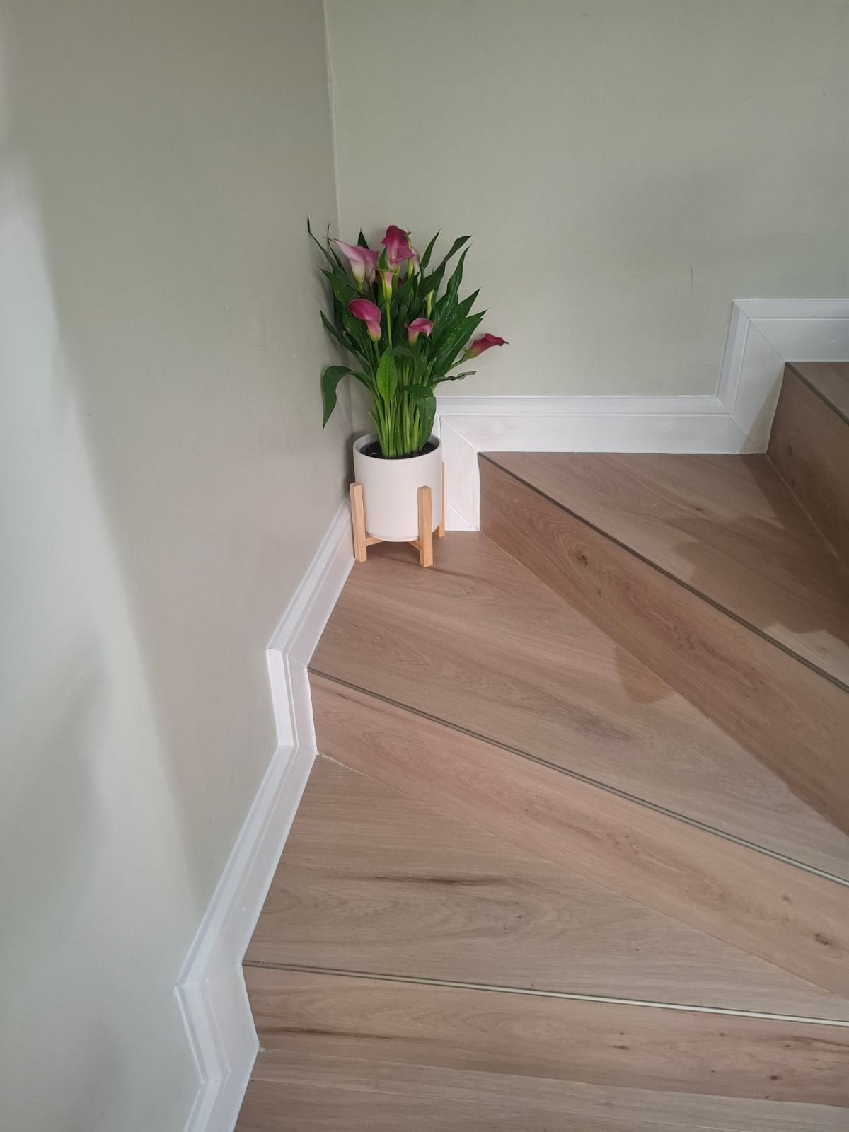 Close-up of the vinyl stair tread and landing with bronze trim detail